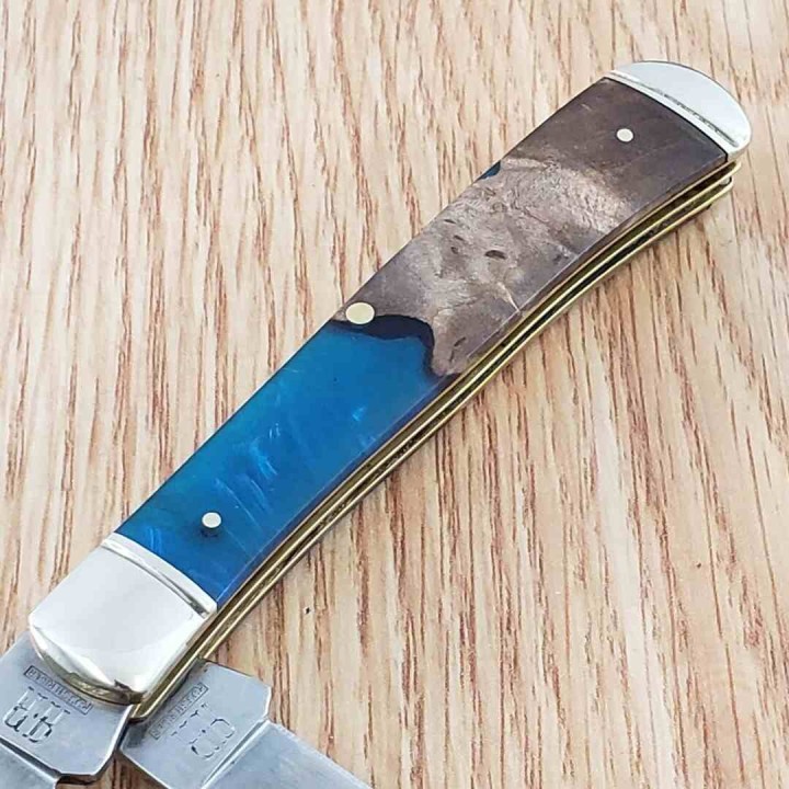 Couteau Rough Rider Pandora Swirl Trapper Lames Clip Point Spey Acier 440 Manche Bois et Résine RR2656 -  Livraison Gratuite